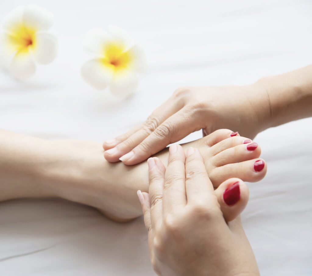 woman receiving foot massage service from masseuse close up hand foot relax foot massage therapy service concept woman receiving foot massage service from masseuse close up hand foot relax foot massage therapy service concept
